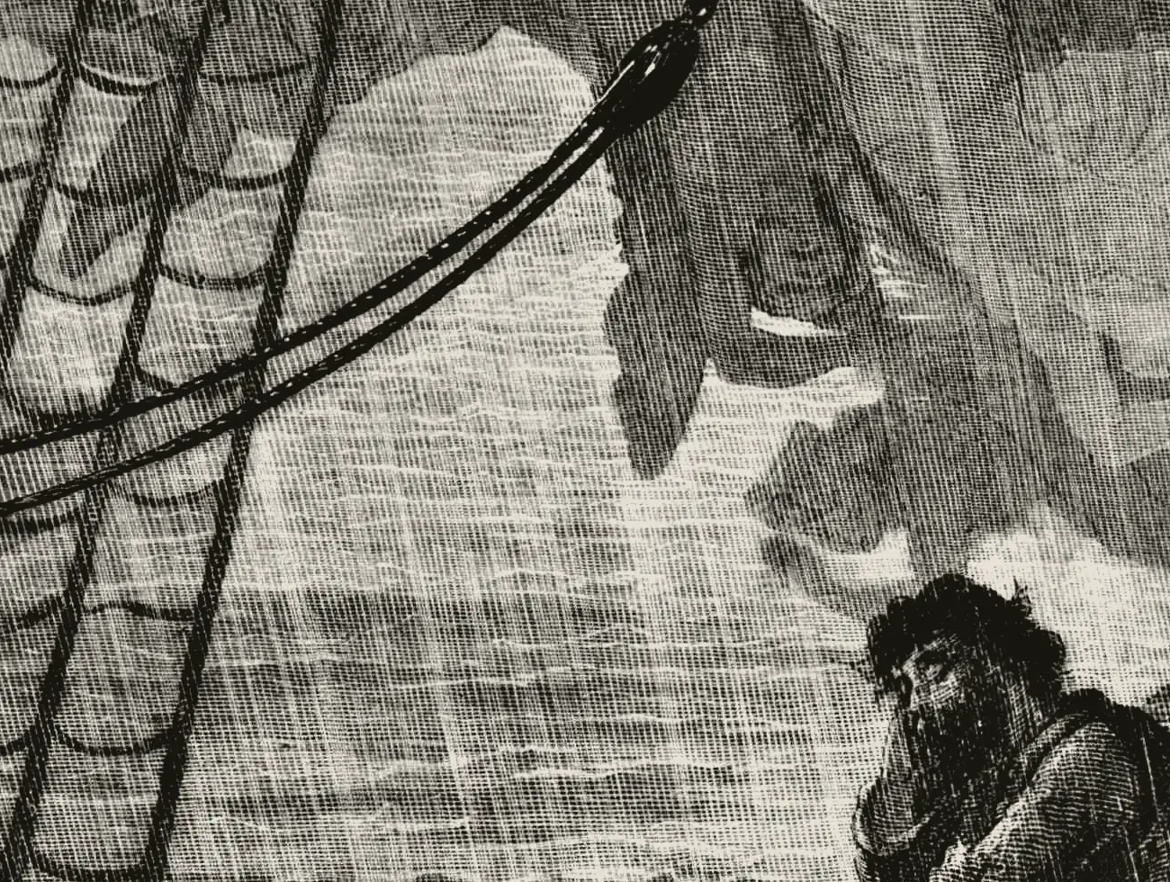 Engraving by Gustave Doré: rain falls across the sea as the mariner leans alone on the ship’s rail